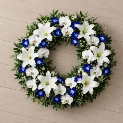 White Lily and Blue Orchid Funeral Wreath whit white orchid , White Waxflower , Greenery .