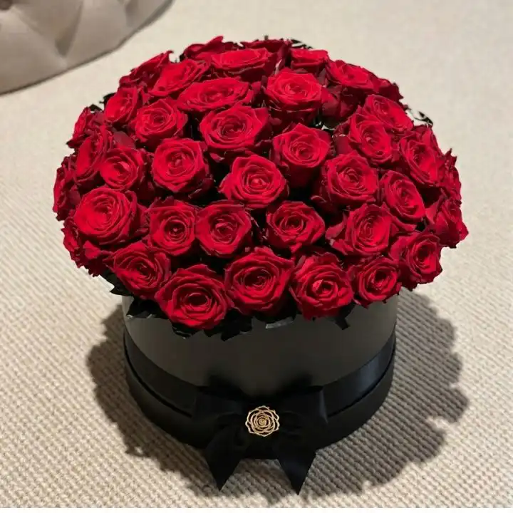 50 Radiant Red Roses in a Luxury Hat Box 1 A luxury black hat box filled with 50 roses in a box creating a dense and elegant floral display.
