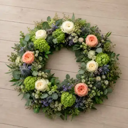 Peach & White Rose Funeral Wreath with Green Hydrangea and blue thistle
