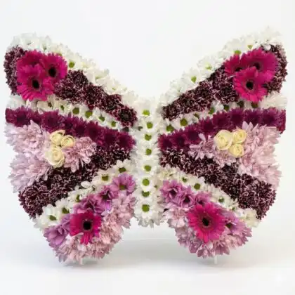 A serene butterfly funeral tribute crafted with fresh white flowers and delicate greenery for a peaceful memorial service.