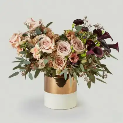Close-up of soft muted pink roses showcasing delicate petals in a sophisticated velvet dusk lighting.