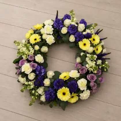 White Rose and Yellow Gerbera Funeral Wreath with Purple Hyacinth ,White Carnation , Purple Veronica .