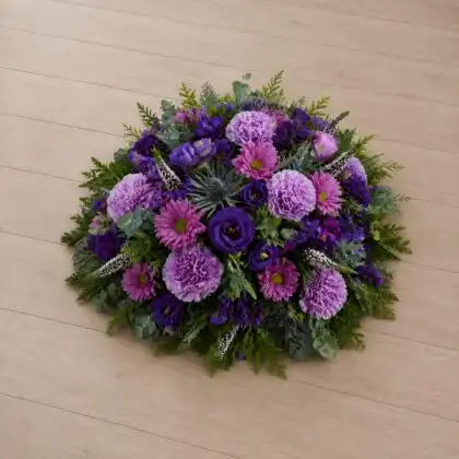 Vibrant Purple Carnation and Lisianthus Funeral Posy with Blue Thistle , purple gerbera, Statice , Veronica,